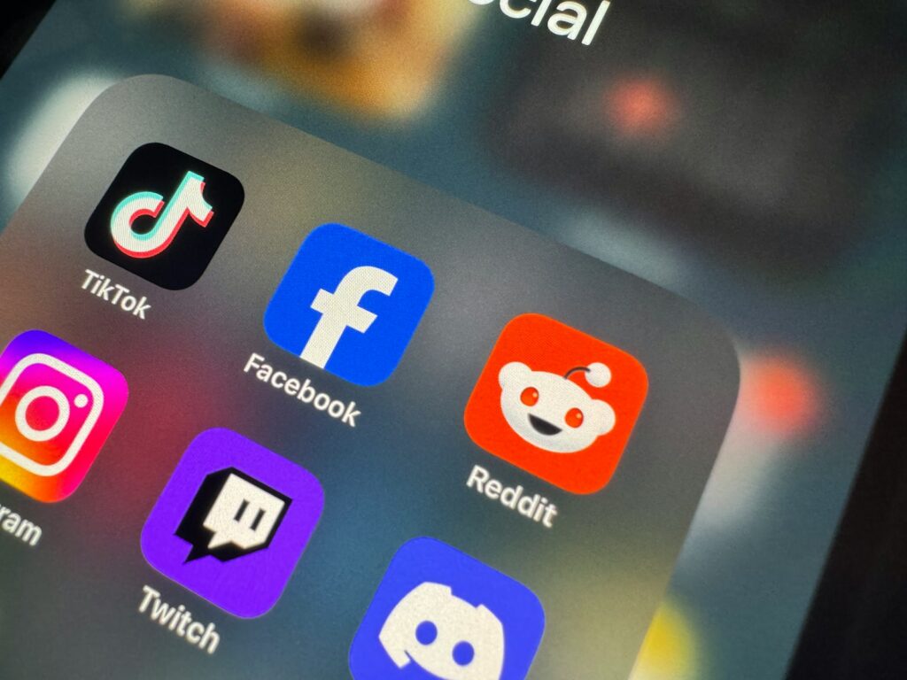 a close up of a cell phone with social icons on it