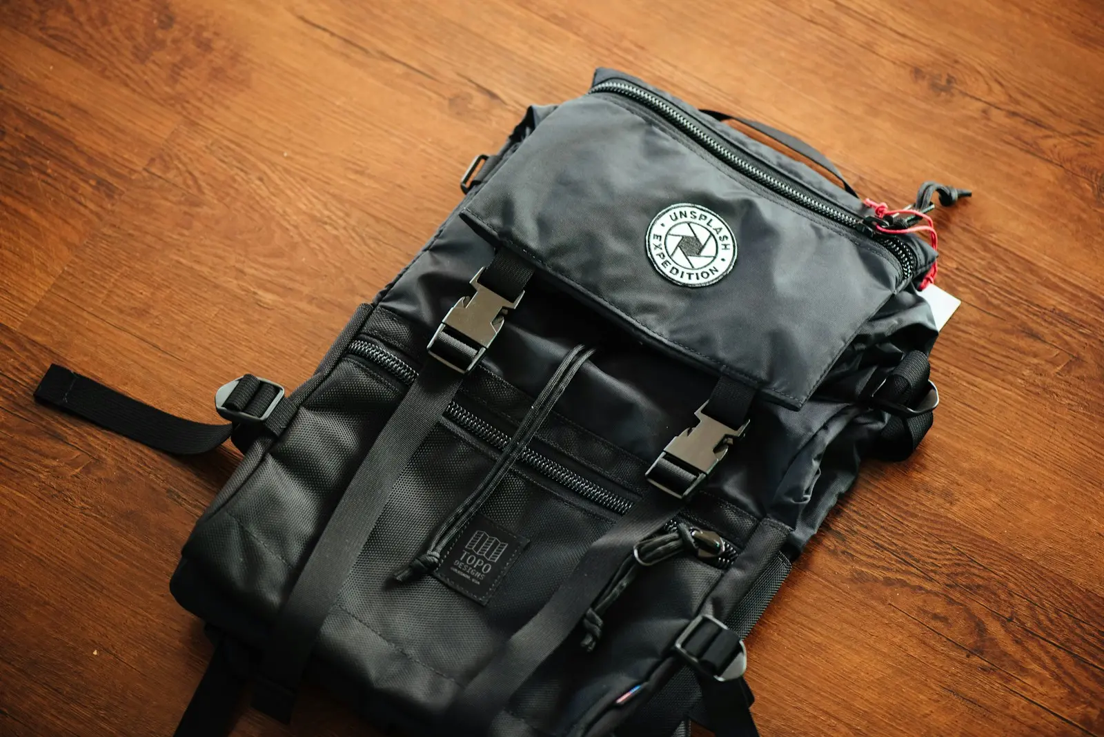 black backpack on wooden deck