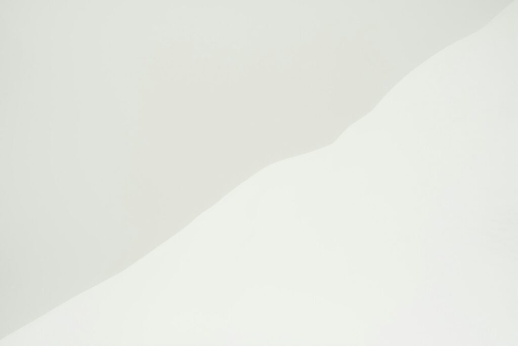 a man riding a snowboard down the side of a snow covered slope