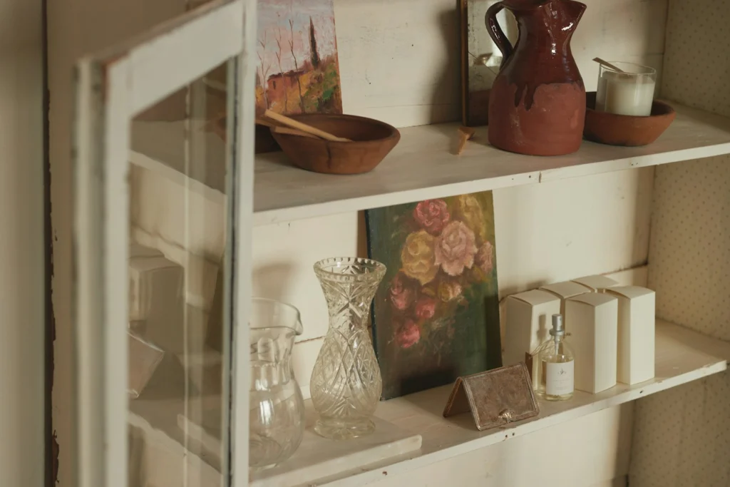A shelf filled with vases and other items