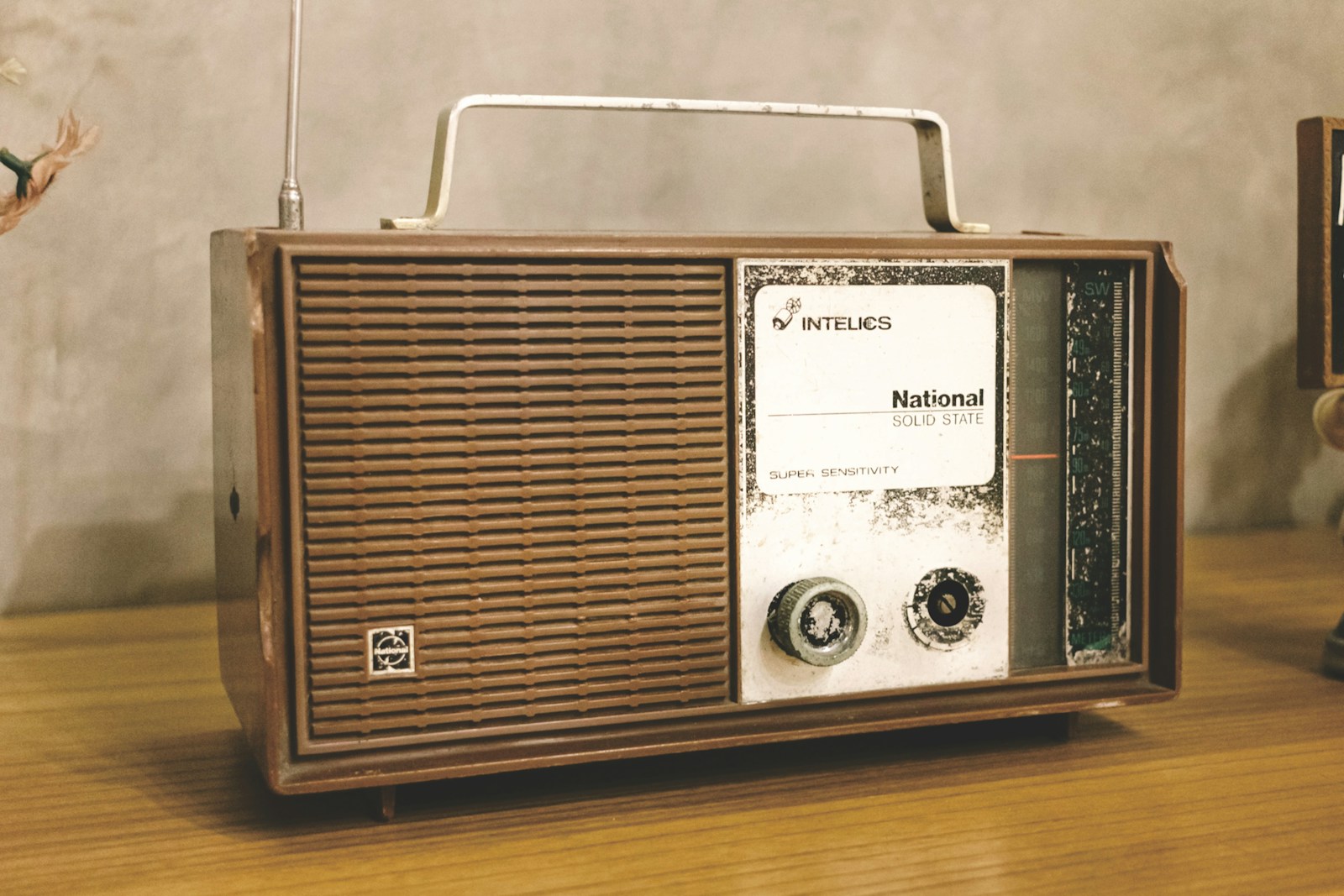 A radio sitting on top of a wooden table