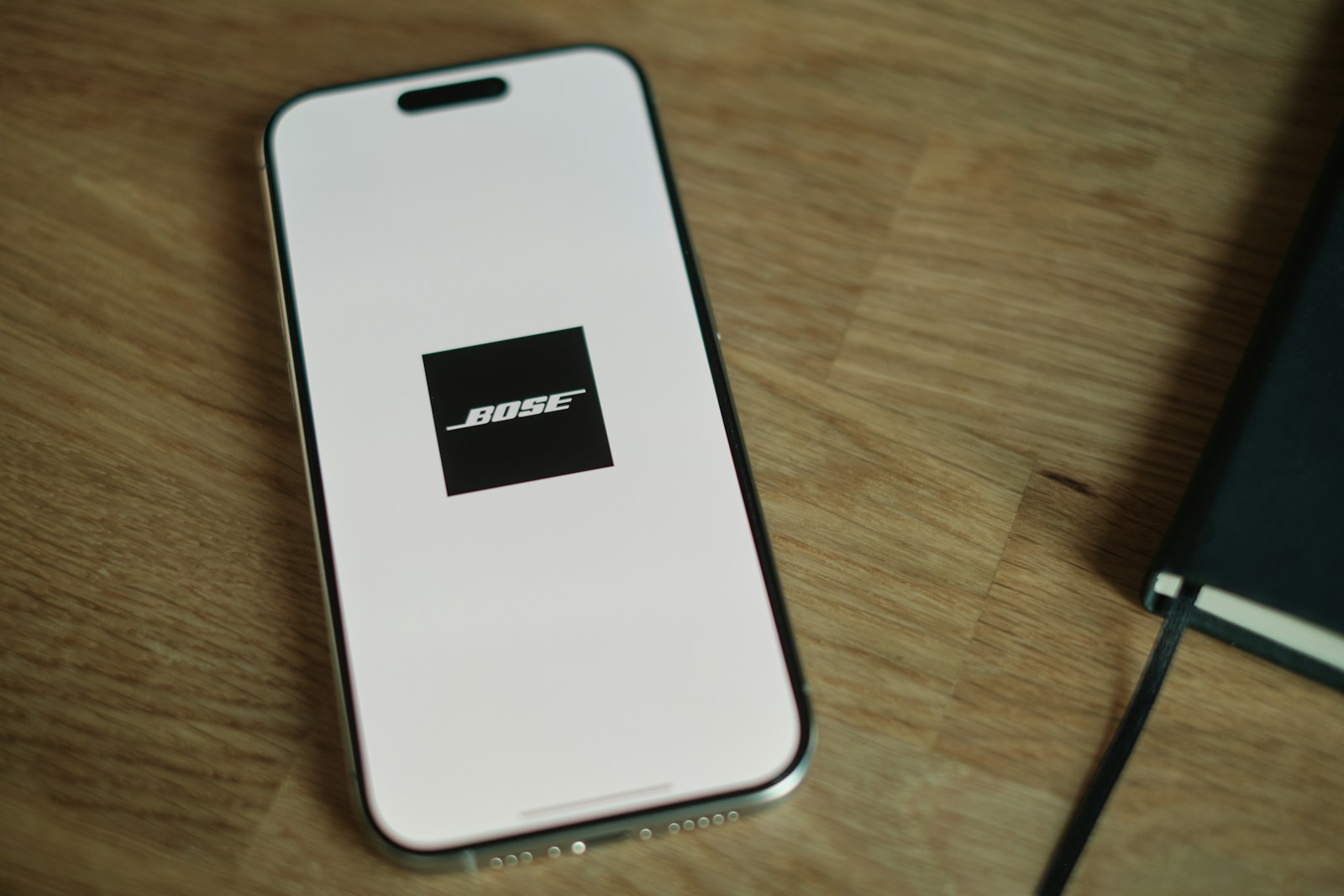 A cell phone sitting on top of a wooden table