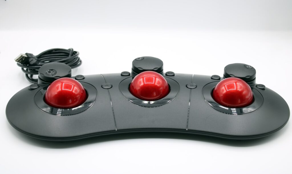 a close up of a controller with three red buttons