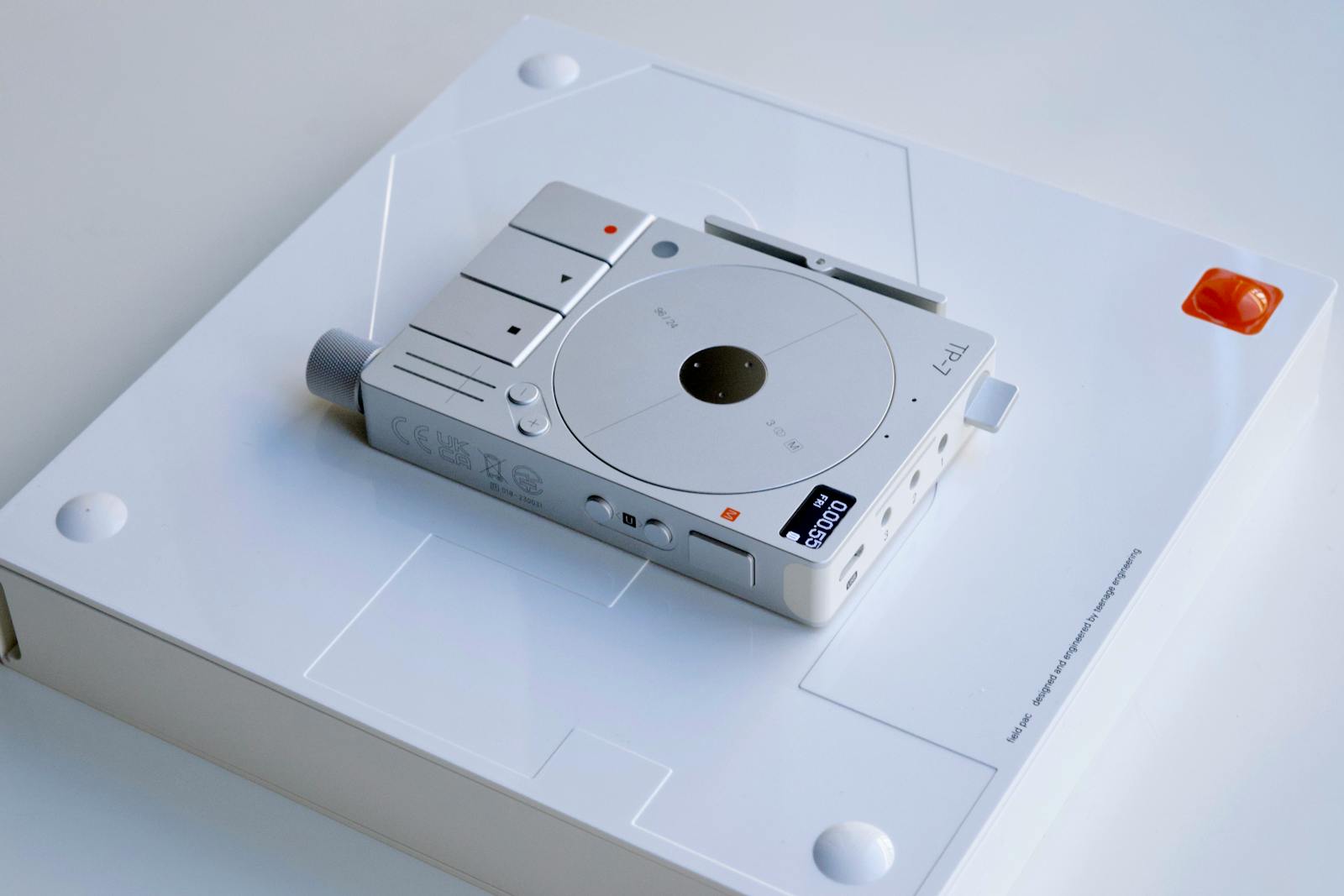 A sleek, modern electronic device placed on a minimalist white background, showcasing advanced technology.