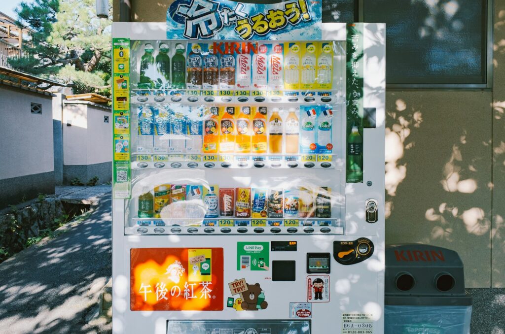 White vending machine filled with drinks and snacks.