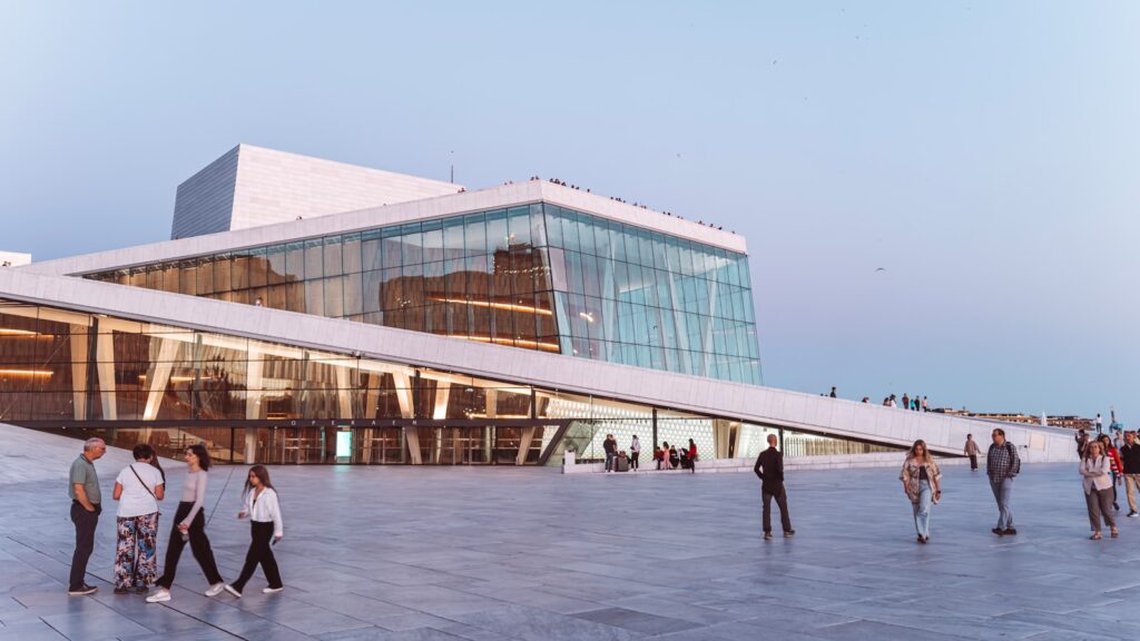 Modern building with glass facade and people walking