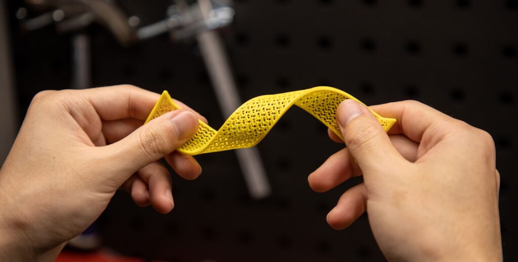 A person holding a yellow ribbon in their hands