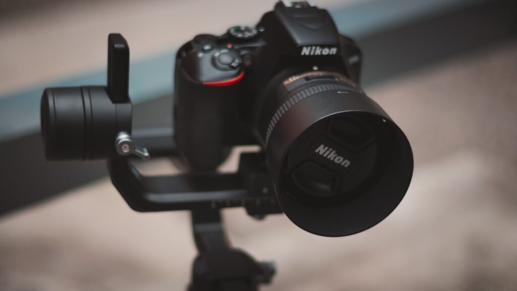 a camera on a tripod with a lens attached to it
