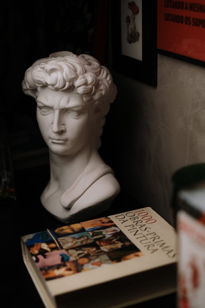 White bust of david with art book