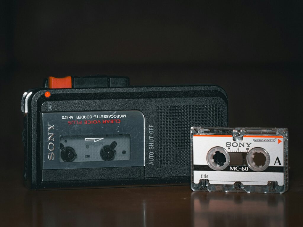 An old radio and a cassette player sitting on a table