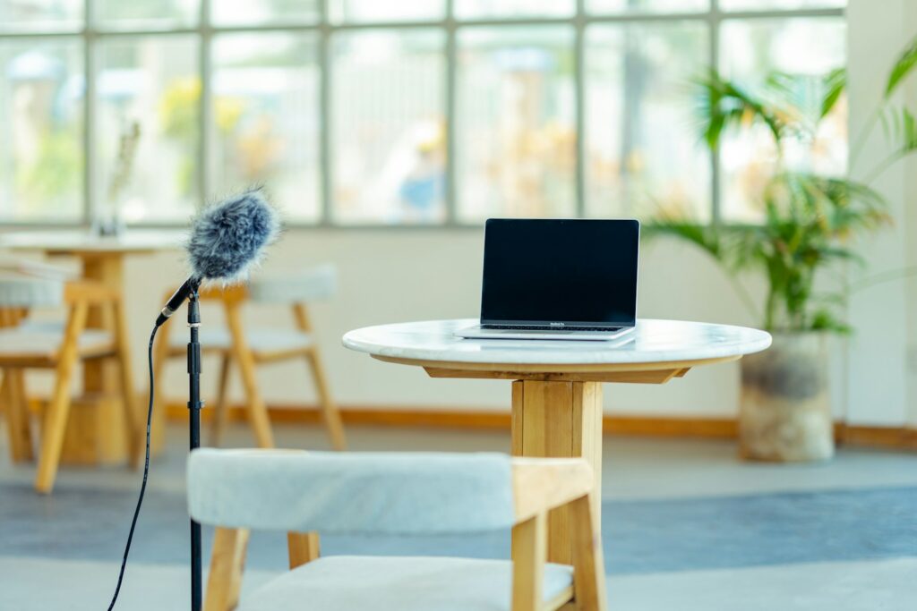 a laptop computer sitting on top of a wooden table