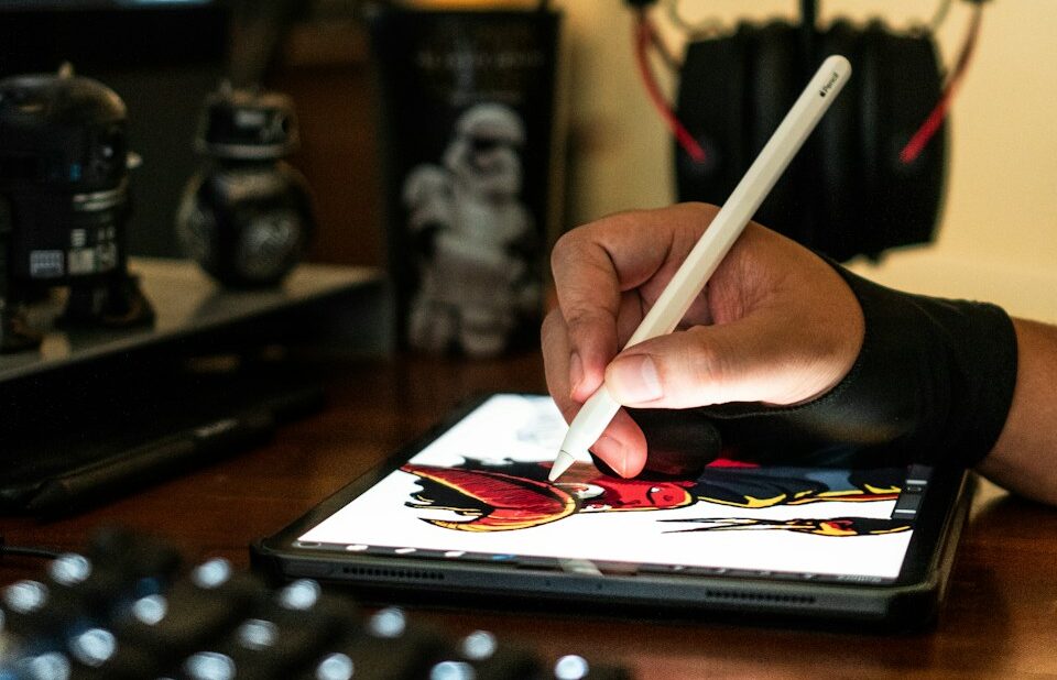 close-up photography of person drawing on tablet computer